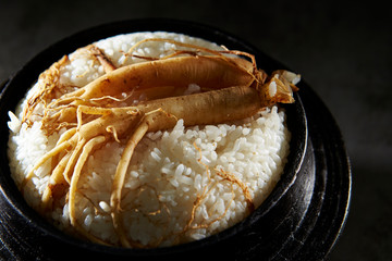 Ginseng root on steamed rice in pot 