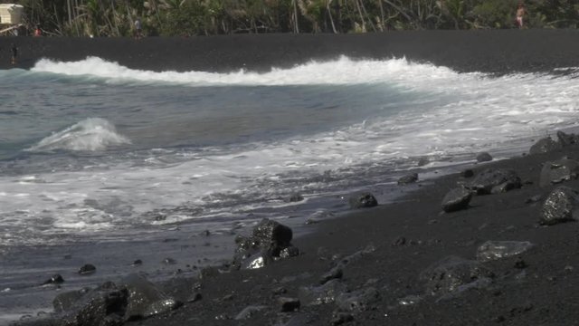 close up of Pohoiki beach break with fisherman in background