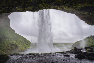 View from a small cave behind famous Seljalandsfoss waterfall in Iceland © Fotokon