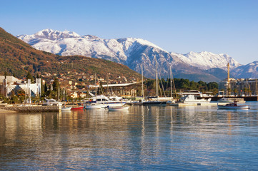 Beautiful winter Mediterranean landscape. Montenegro, Bay of Kotor. View of snowy Lovcen mountain and Tivat city