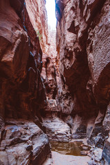 Tourist climbs on the rocks in the canyon of Khazali. Wadi Rum Desert, Jordan