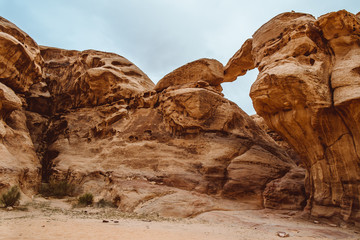 View through a rock arch in the desert of Wadi Rum, Jordan, Middle East