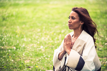 attractive woman practicing yoga in nature