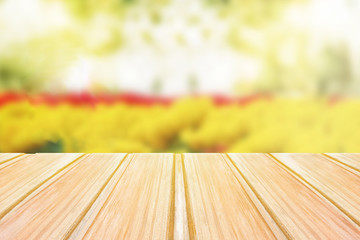 Empty wooden table with blurred spring background, bokeh of flowers and Park