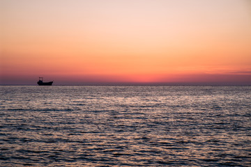 Fototapeta na wymiar sailing boat sunset at beach in Cyprus