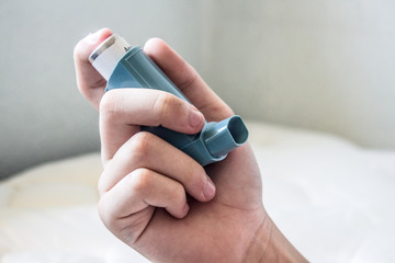 hand holding asthma medicine