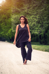 attractive woman practicing yoga in park