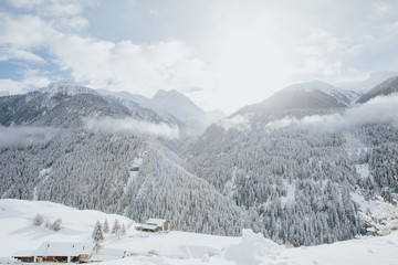 Fototapeta na wymiar Lonely mountain shelter in snowcapped mountains