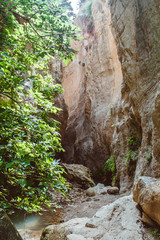 Fototapeta na wymiar Stuck Hanging Stone in Avakas canyon. Akamas Peninsula landscape. Cyprus landmark