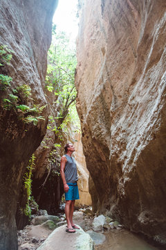 Young caucasian tourist in beautiful Avakas Gorge valley during trekking. Landscape taken on Cyprus island.