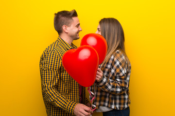 Fototapeta na wymiar Couple in valentine day with balloons with heart shape