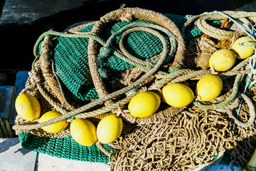 Green fishing net with yellow floating balls and thick rope