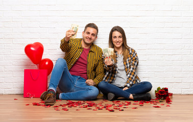Couple in valentine day at indoors taking a lot of money
