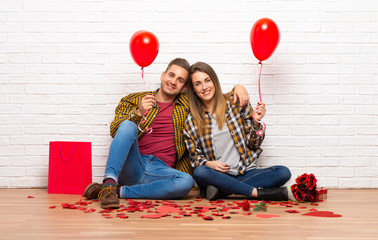 Couple in valentine day at indoors with balloons with heart shape