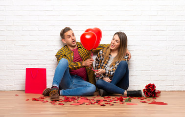 Couple in valentine day at indoors with balloons with heart shape