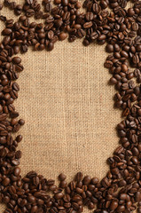 Closeup of coffee beans on burlap background