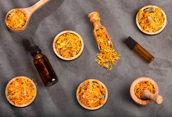 Aromatherapy essential oil with marigold flowers - Calendula officinalis. Top view
