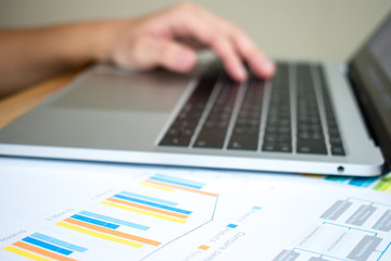 Close-up pictures of the work desk of accountants working on laptop computers, financial business reports.