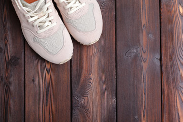 Fototapeta na wymiar sneakers on old retro wooden background.