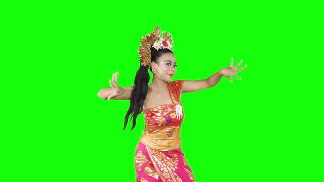Beautiful balinese dancer performing a dance in the studio while wearing traditional clothes. Shot in 4k resolution