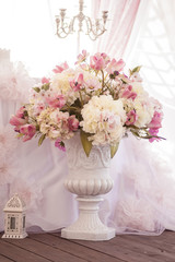 Part of the decor of the holiday table. Wedding day. Luxury pot with flowers.