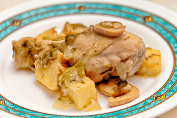 A chicken drumstick cooked with mushrooms