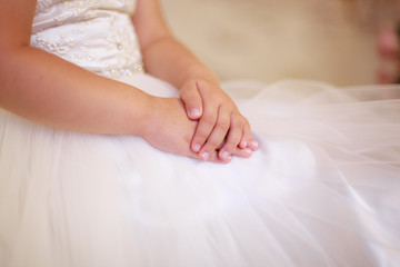 Obraz na płótnie Canvas tender baby hands, girl in dress, tulle, closeup