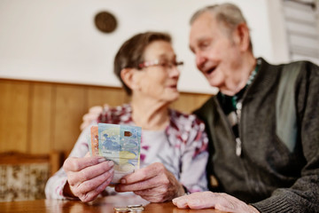 Senior, Seniorin, Seniorenpaar zählt liebevoll ihr gemeinsames Geld