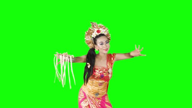 Attractive female balinese dancer showing a dance in the studio. Shot in 4k resolution with green screen background