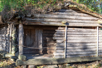 Old wooden log-crib dwelling of the ancient tribe of Latgallians in a reconstructed Stone Age settlement of Archaeological Site in Gauja National Park, Araisi, Latvia.