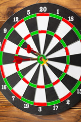The darts on wooden background