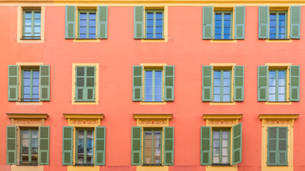 Fototapeta premium Nice, colorful facade, with typical windows and green shutters
