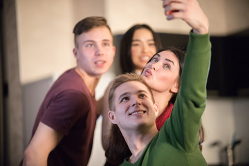 Fototapeta premium Young friends taking a selfie and posing