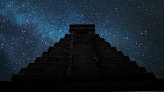 Ancient Mayan pyramid ( Kukulcan Temple ) by Night, Time Lapse with with Stars and Milky Way in Background , UNESCO world heritage site, Chichen Itza, Yucatan, Mexico.