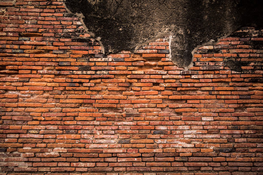 Old brick stone wall exterior on ancient temple architecture in Ayutthaya, Thailand. © Worayuth