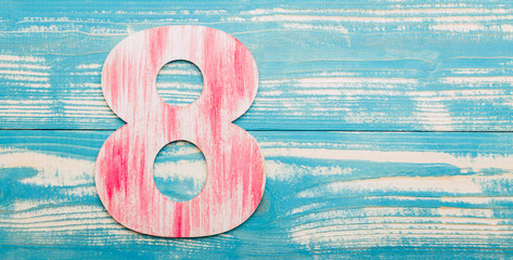 Women's day, number 8 on a blue wooden background, banner, copy space