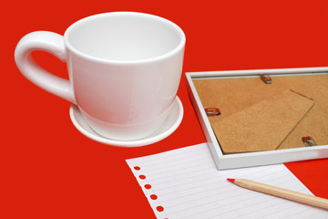 Planning with the coffee in the morning. White cup with writing sheet and pencil. St. Valentine letter. Love and coffee. Mug, note sheet and pencil. Copy space. 