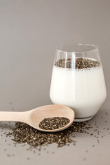 kefir in a glass cup and chia seeds in a wooden spoon. proper balanced healthy diet, weight...