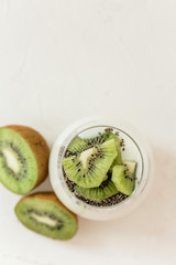 pudding of kefir Chia and kiwi seeds in a glass on a light background horizontally.Portion of...