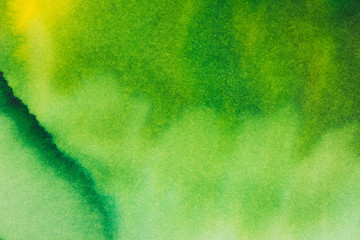 Abstract bright watercolor background. Smooth transitions from green to yellow on textured paper