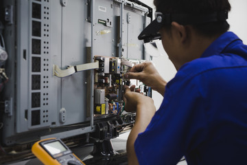Young technician repairing a television LCD
