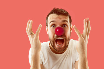 The happy surprised and smiling man on red nose day. The clown, fun, party, celebration, funny,...