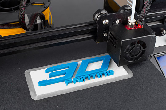 3d printer printing logo symbol with white blue pla filament science technology future hobby concept