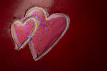 two hearts painted on stone, red background, valentine's day concept,copy space.