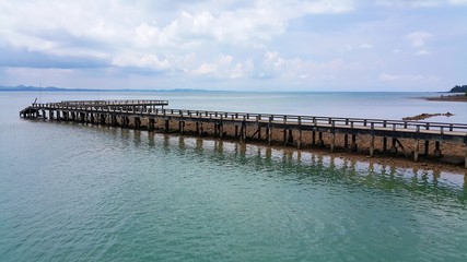 Fototapeta na wymiar long wooden pier going far into the sea
