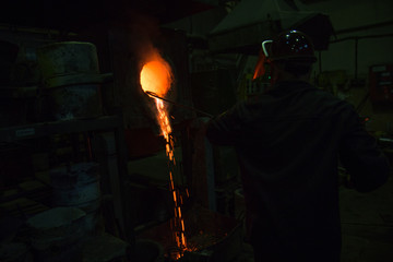 Worker of foundry production. The burning metal