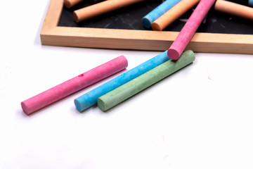 Colorful chalk spread  on wooden blackboard.For student,teacher,children or who want to draw something.