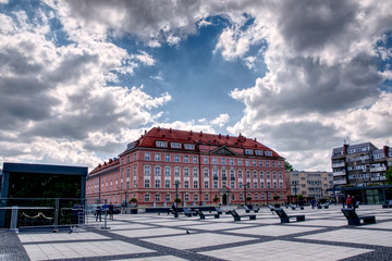 Wroclaw, Poland, town square. This picture shows town square of Wroclaw, Poland. There is an old tenement house in the middle. Dark and light clouds makes a view with full of contrast.