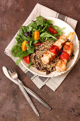 Healthy dinner.Grilled chicken and quinoa, mix salad and tomato 