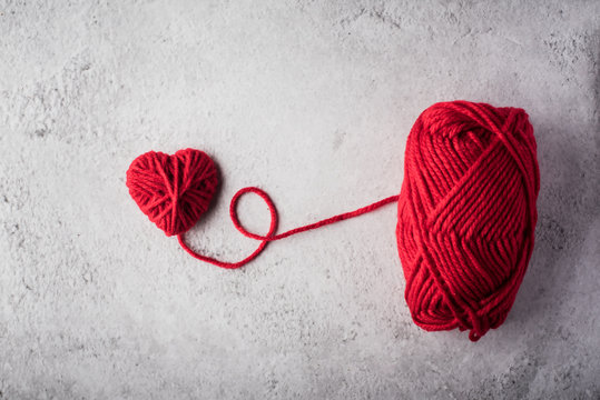 Red Yarn Heart Shaped On The Wall Background